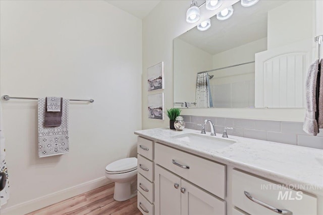12740 S Alzano Way, Nampa, ID 83686 - full bathroom with vanity, decorative backsplash, wood finished floors, toilet, and a shower with curtain