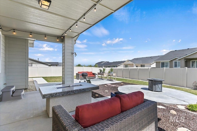 12740 S Alzano Way, Nampa, ID 83686 - fenced backyard featuring an outdoor living space with a fire pit, a patio area, and a residential view