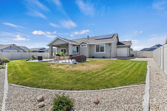 12740 S Alzano Way, Nampa, ID 83686 - rear view of house featuring solar panels, an attached garage, a patio area, a shingled roof, and a gate