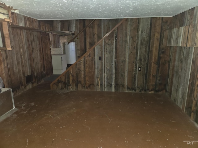 below grade area featuring wooden walls and water heater