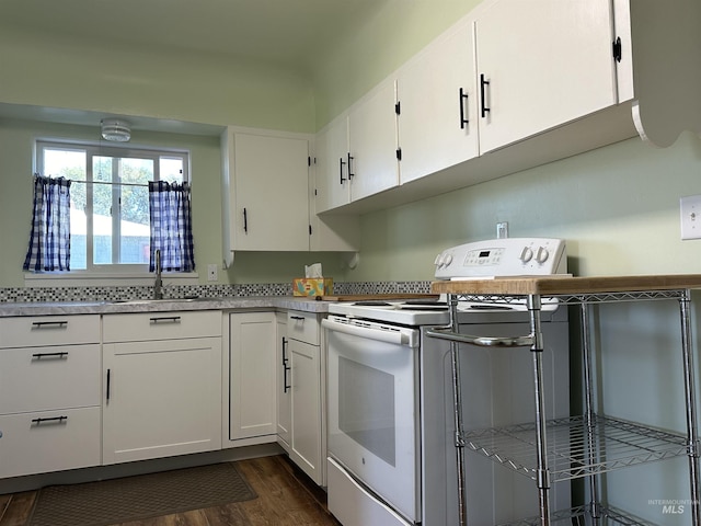 kitchen with white electric stove, dark wood-style flooring, a sink, white cabinetry, and light countertops