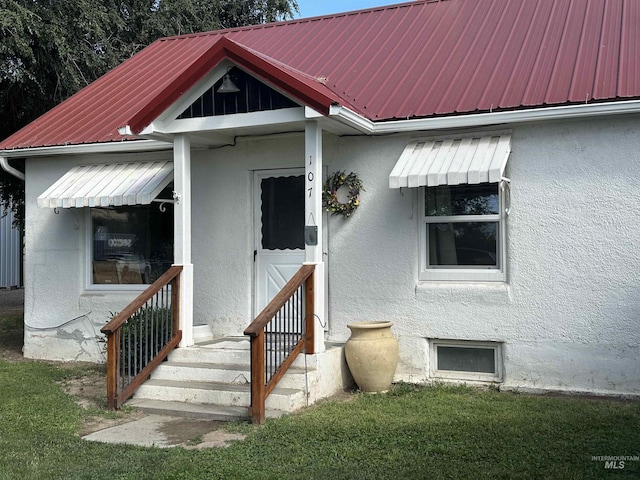 exterior space featuring metal roof and stucco siding