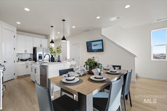 dining room featuring visible vents, recessed lighting, and light wood-style floors