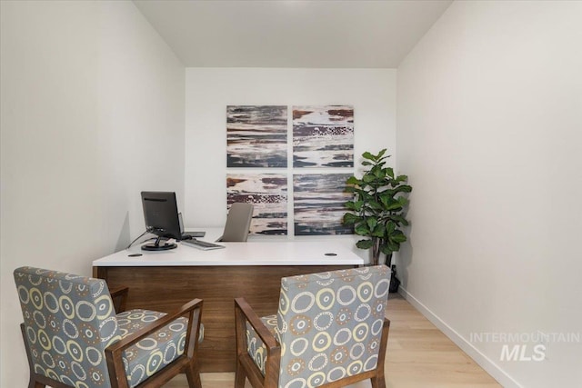 office area with baseboards and wood finished floors