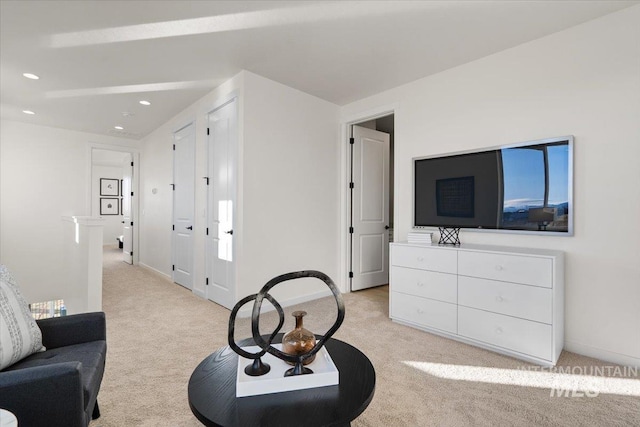 living area featuring an upstairs landing, light colored carpet, recessed lighting, and baseboards