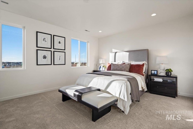 bedroom featuring recessed lighting, multiple windows, light colored carpet, and baseboards