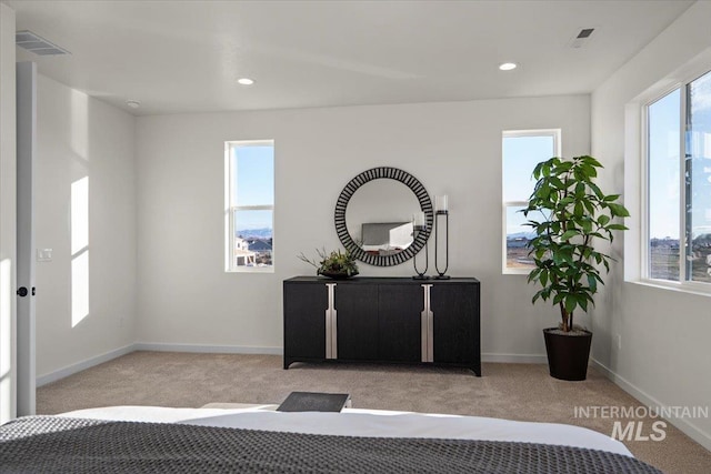 carpeted bedroom featuring recessed lighting, baseboards, and visible vents