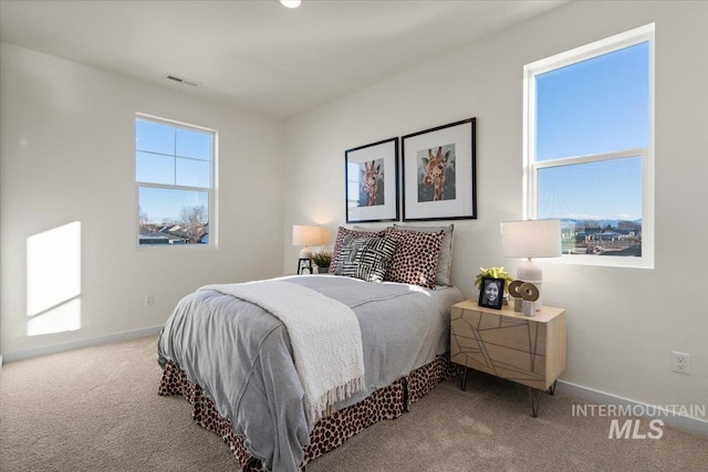 carpeted bedroom with baseboards and visible vents