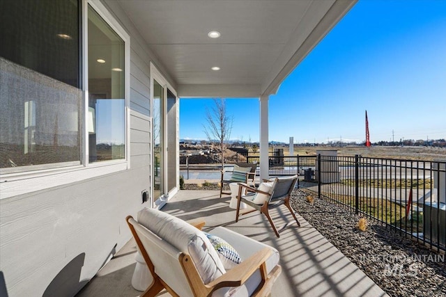 view of patio with outdoor lounge area and fence