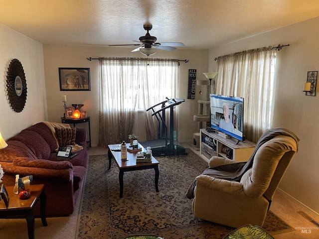 carpeted living room featuring a wealth of natural light, a textured ceiling, and ceiling fan
