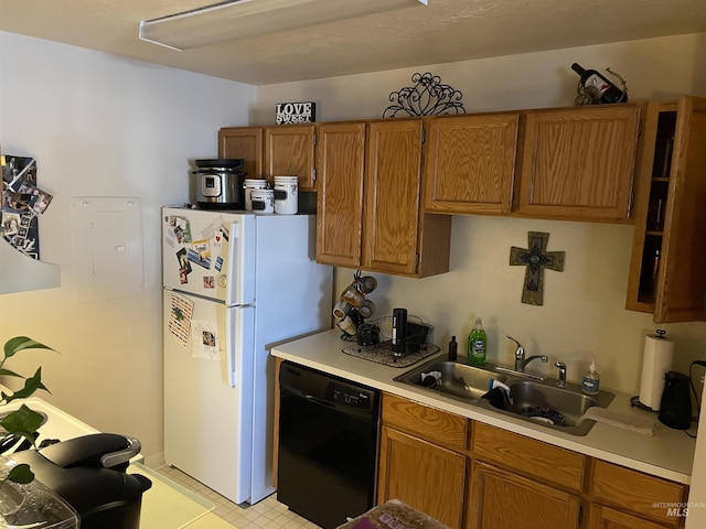 kitchen with sink, black dishwasher, and white fridge