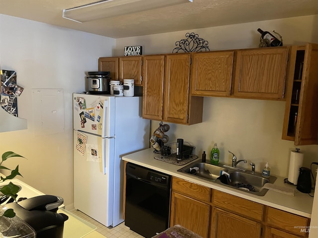 kitchen featuring sink, dishwasher, and white fridge