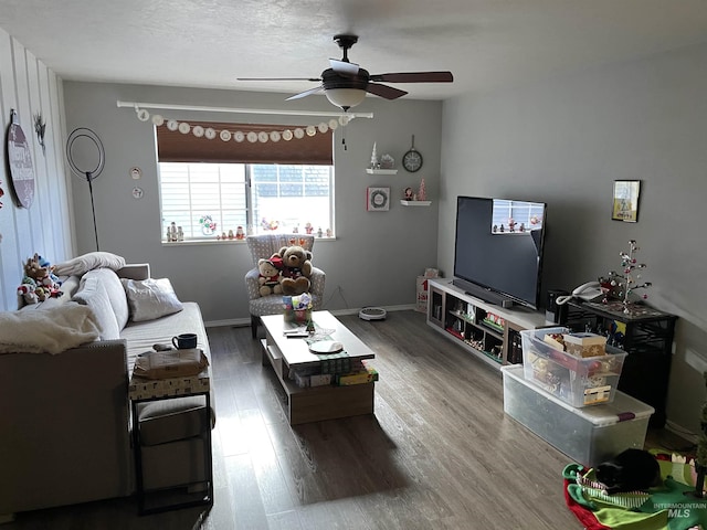 living room featuring hardwood / wood-style flooring, a textured ceiling, and ceiling fan