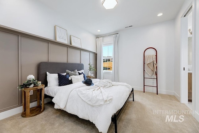 bedroom featuring light carpet