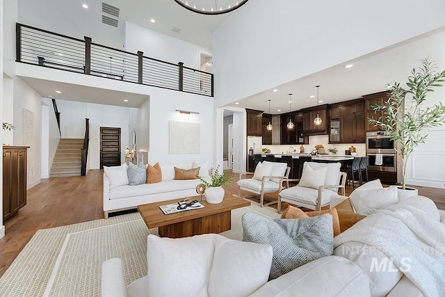 living room with hardwood / wood-style floors and a high ceiling