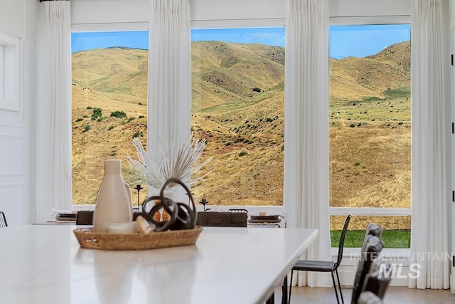 unfurnished dining area with a mountain view and plenty of natural light