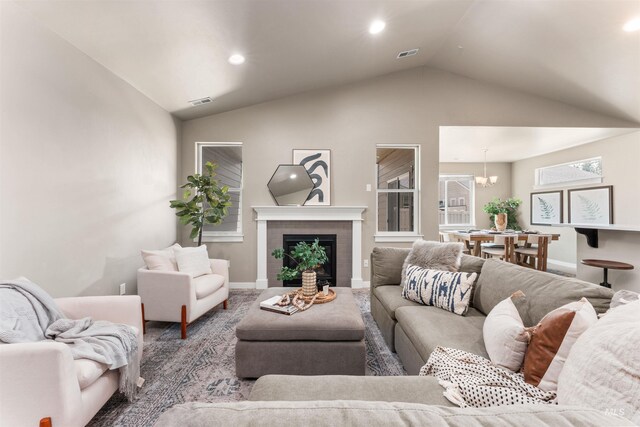 12457 W Awbrey St, Boise, ID 83709 - living room with vaulted ceiling, a chandelier, recessed lighting, and a brick fireplace