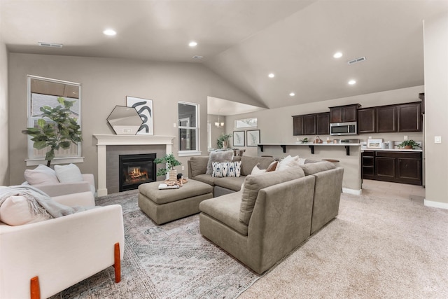 12457 W Awbrey St, Boise, ID 83709 - living room featuring recessed lighting, lofted ceiling, a glass covered fireplace, light carpet, and a chandelier