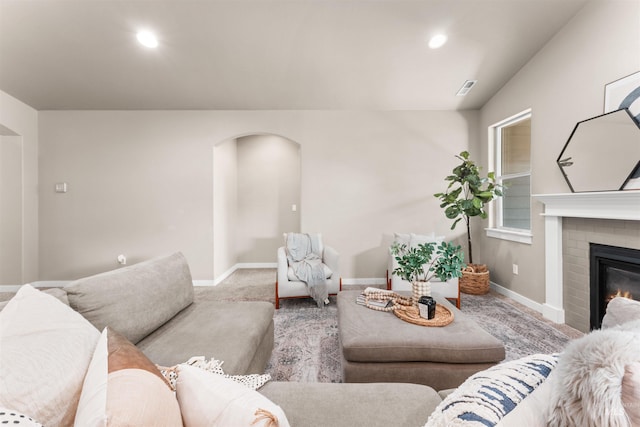 12457 W Awbrey St, Boise, ID 83709 - living room featuring arched walkways, carpet flooring, a fireplace, and recessed lighting