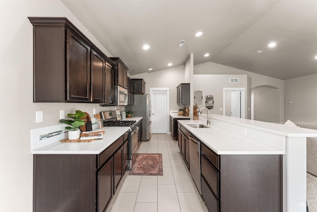 12457 W Awbrey St, Boise, ID 83709 - kitchen with stainless steel appliances, dark brown cabinets, light countertops, lofted ceiling, and light tile patterned floors
