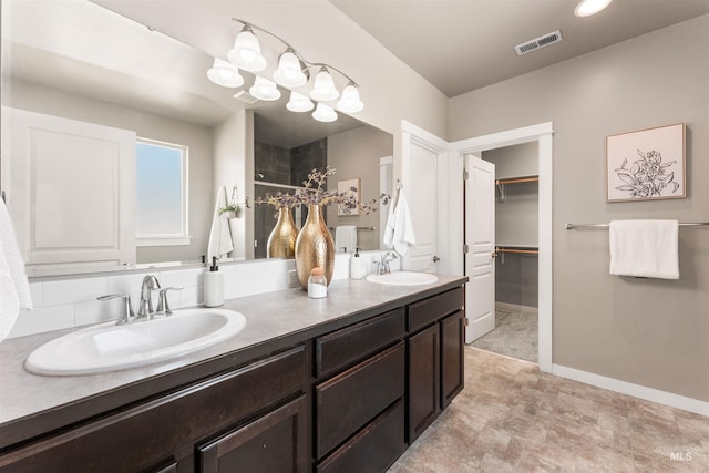 12457 W Awbrey St, Boise, ID 83709 - full bathroom featuring double vanity, tiled shower, and a walk in closet