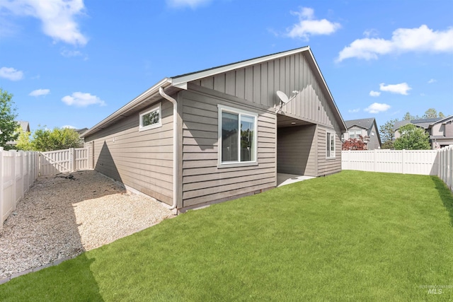 12457 W Awbrey St, Boise, ID 83709 - rear view of house with board and batten siding and a fenced backyard