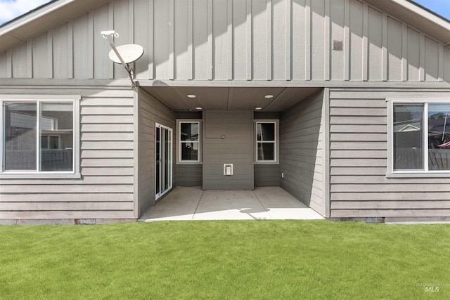 12457 W Awbrey St, Boise, ID 83709 - rear view of house featuring a patio area, a lawn, and board and batten siding