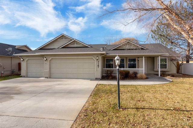 ranch-style home featuring covered porch, a front lawn, and a garage