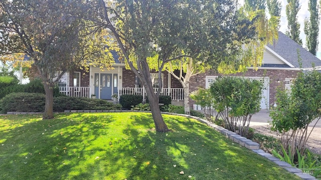 obstructed view of property with a front yard