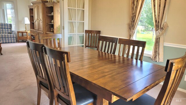 dining room with light colored carpet