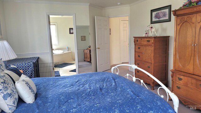 bedroom featuring ornamental molding, connected bathroom, and carpet floors