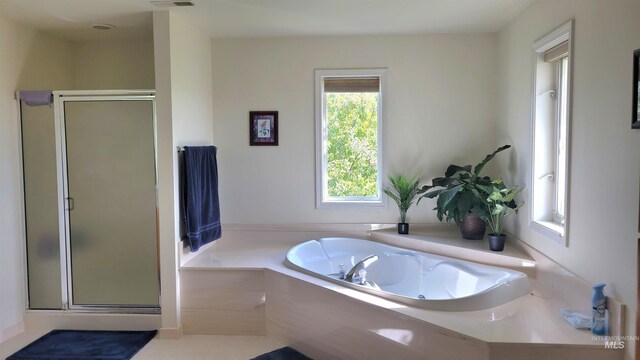 bathroom featuring shower with separate bathtub