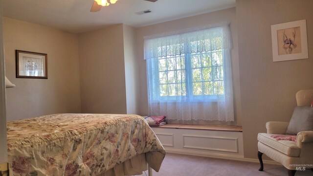 bedroom featuring ceiling fan and light colored carpet