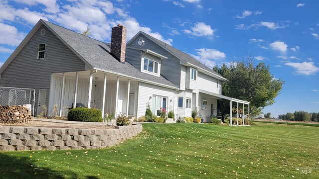 back of house featuring a lawn