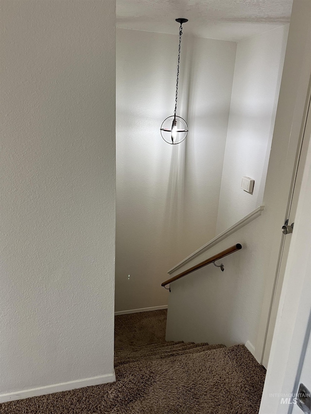 stairs with baseboards and carpet flooring