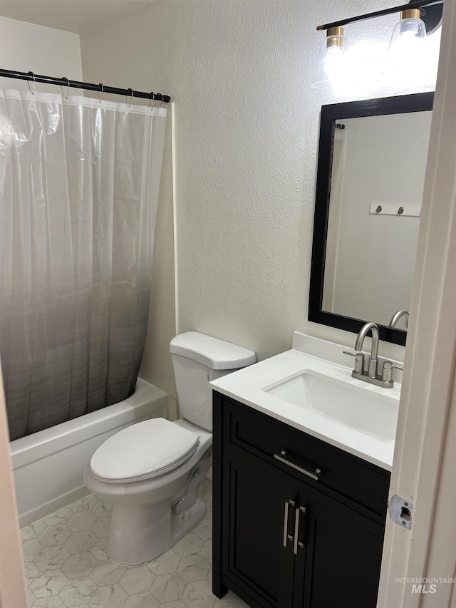 full bathroom with vanity, toilet, a textured wall, and shower / tub combo