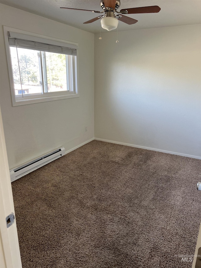 carpeted empty room with baseboards, a ceiling fan, and a baseboard heating unit