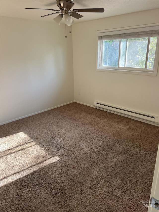 carpeted spare room with baseboards, a ceiling fan, and baseboard heating