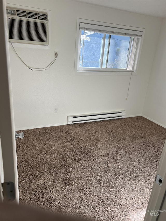 spare room featuring a healthy amount of sunlight, baseboards, a baseboard radiator, and a wall mounted AC
