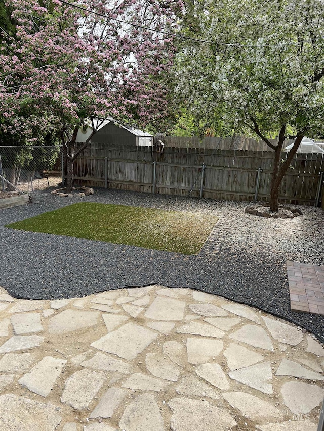 view of yard with a fenced backyard and a patio
