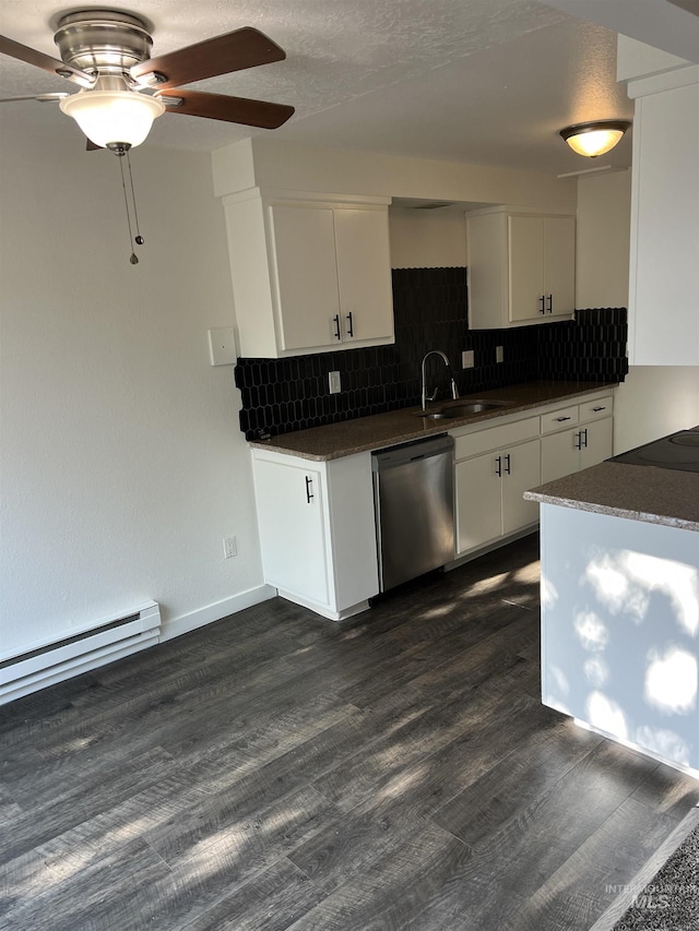 kitchen featuring a sink, dishwasher, ceiling fan, backsplash, and dark countertops