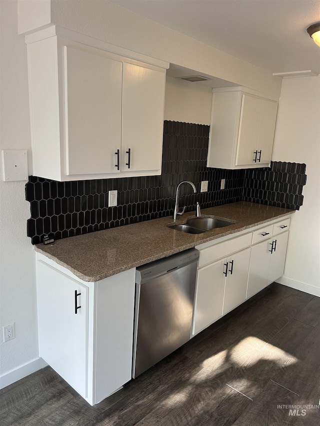 kitchen featuring baseboards, white cabinets, a sink, and dishwasher