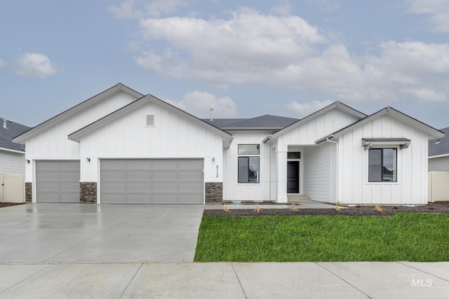 2326 N Lithodora Ave, Star, ID 83669 - modern inspired farmhouse featuring concrete driveway, a garage, a front lawn, board and batten siding, and a shingled roof