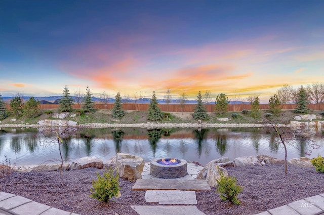 property view of water featuring a fire pit