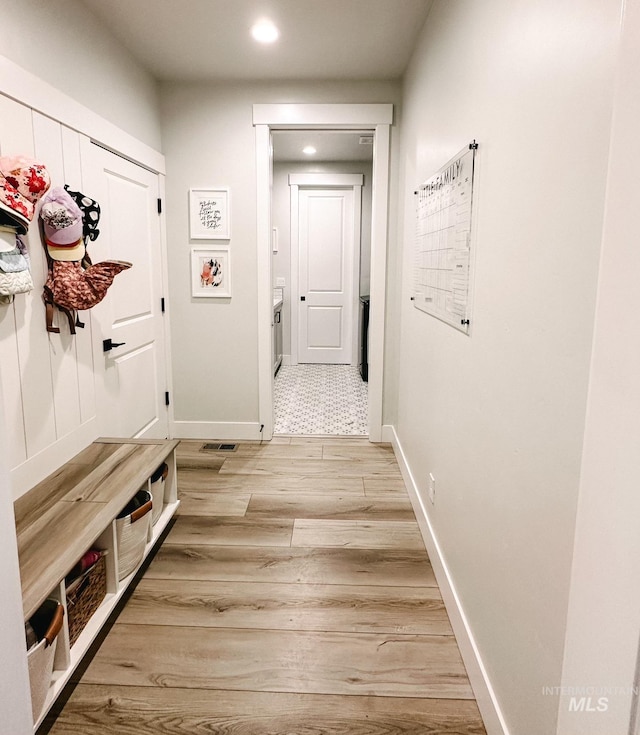 mudroom with hardwood / wood-style flooring