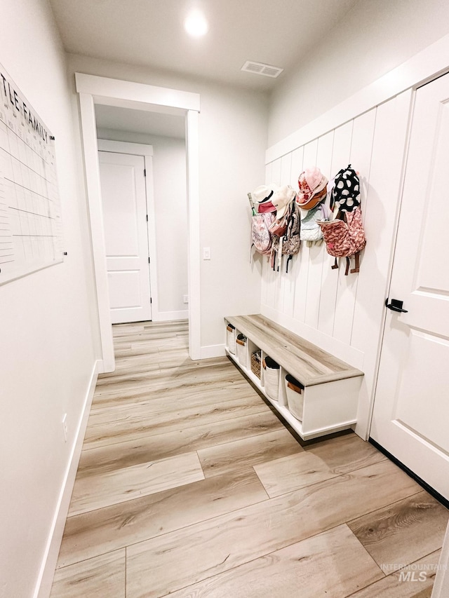 mudroom with light hardwood / wood-style floors