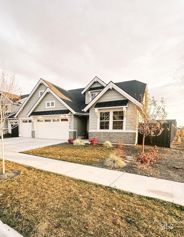 craftsman-style home featuring a garage and a front yard