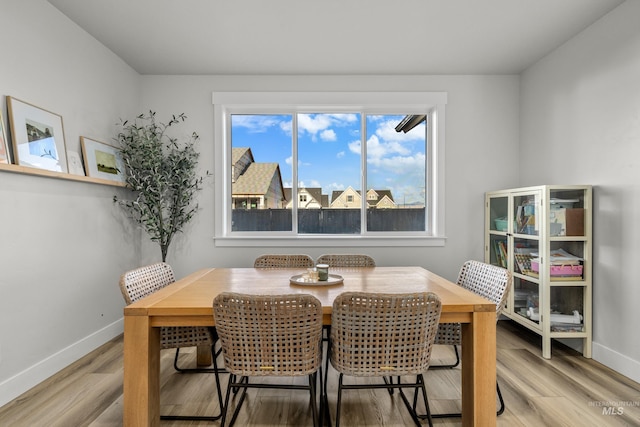 dining space with hardwood / wood-style flooring