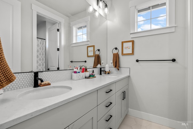 bathroom with tile patterned floors, plenty of natural light, and vanity