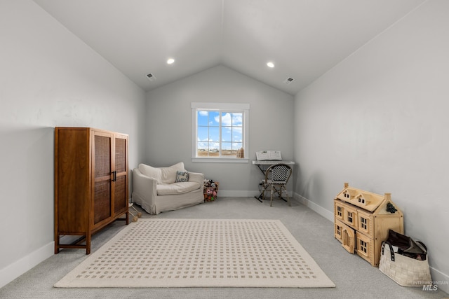 living area featuring carpet and vaulted ceiling